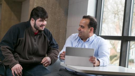 student and professor smiling